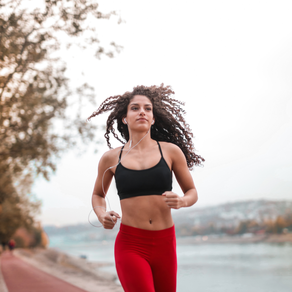 white curly hair girl in red leggy ad black bra,  running and listening to music