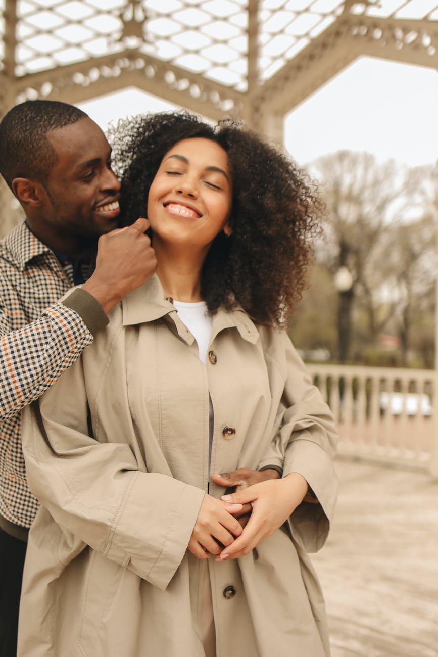 man hugging woman from behind