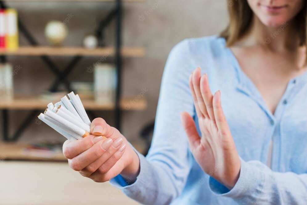 Girl signing "stop smoking cigarettes"