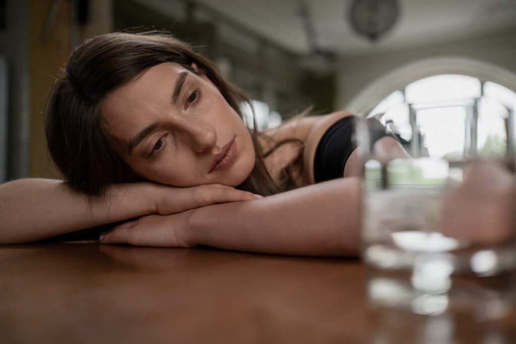 sad woman on a wooden table crying over a heartbreak