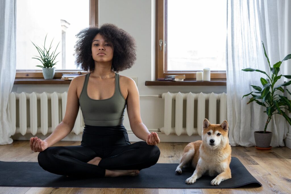 woman doing yoga to deal with her heartbreak