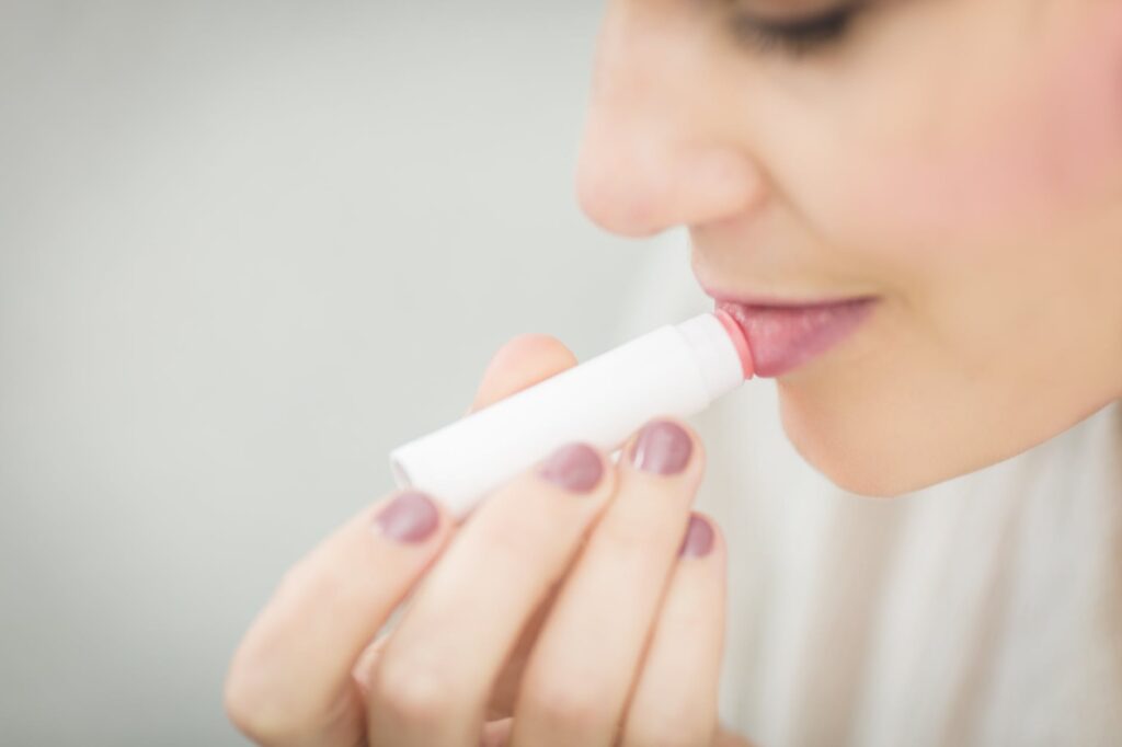 woman putting lipbalm